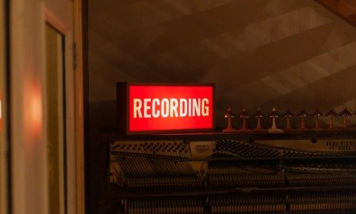 Red sign with white letters reading "Recording"