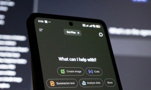 Phone with black screen set to AI homepage and What can I help With message on top of a prompt box.