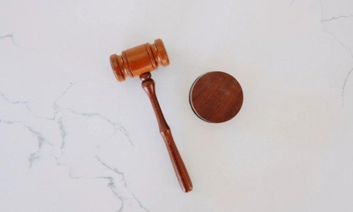 Brown gavel on a marble desktop