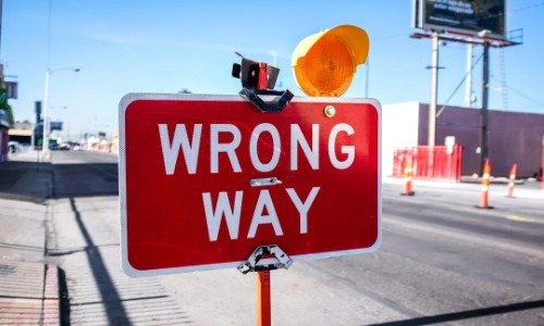Wrong Way sign oaside a road