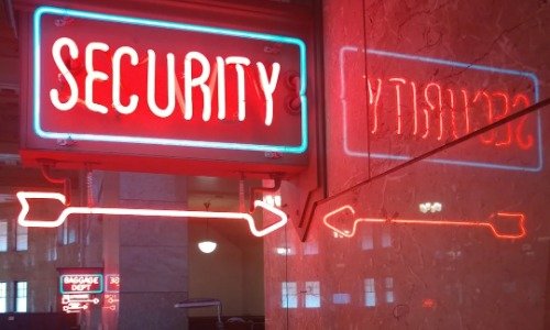 Neon light that reads Security